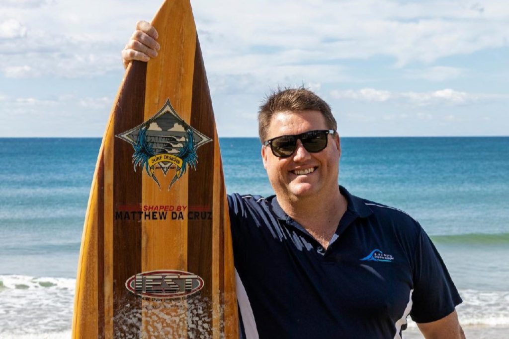 Chris-with-board - Blue Wave